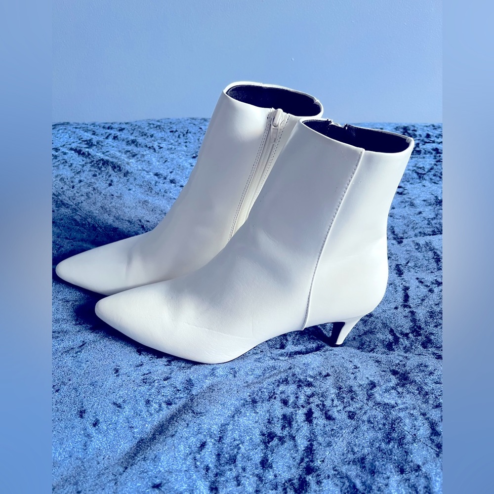 Mid-ankle, white booties.